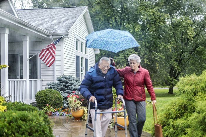 husband and wife walking in rain