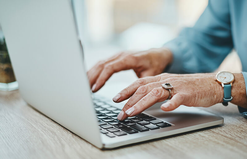 hands on laptop keyboard